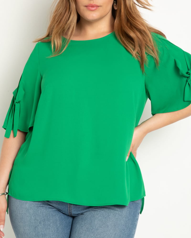 Front of a model wearing a size 26 Relaxed Top With Tie Sleeve in Jelly Bean by ELOQUII. | dia_product_style_image_id:300079